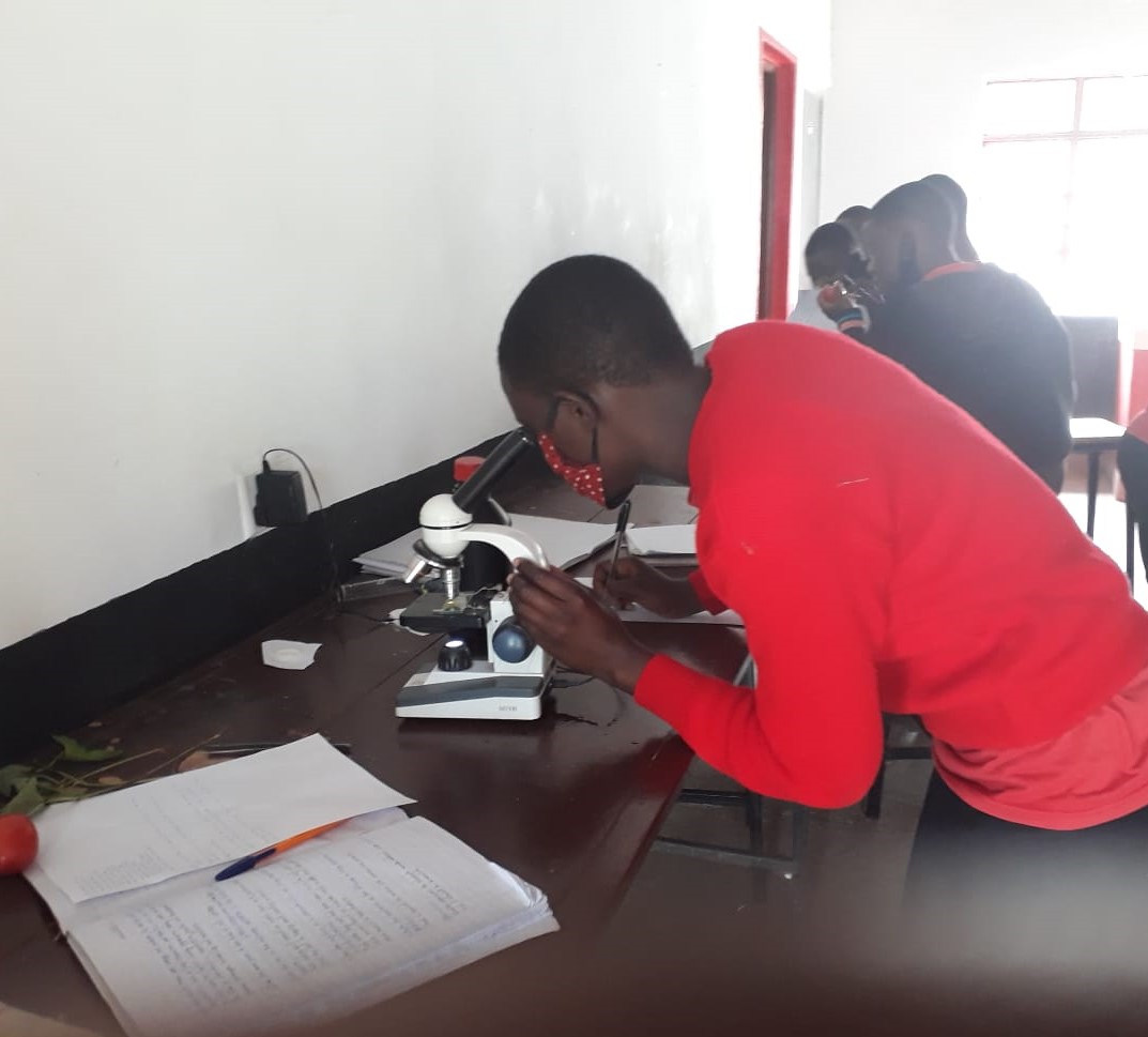 JAMS Form Four student uses a microscope in Sparks Lab November 2020