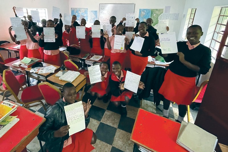 Students holding up their writing