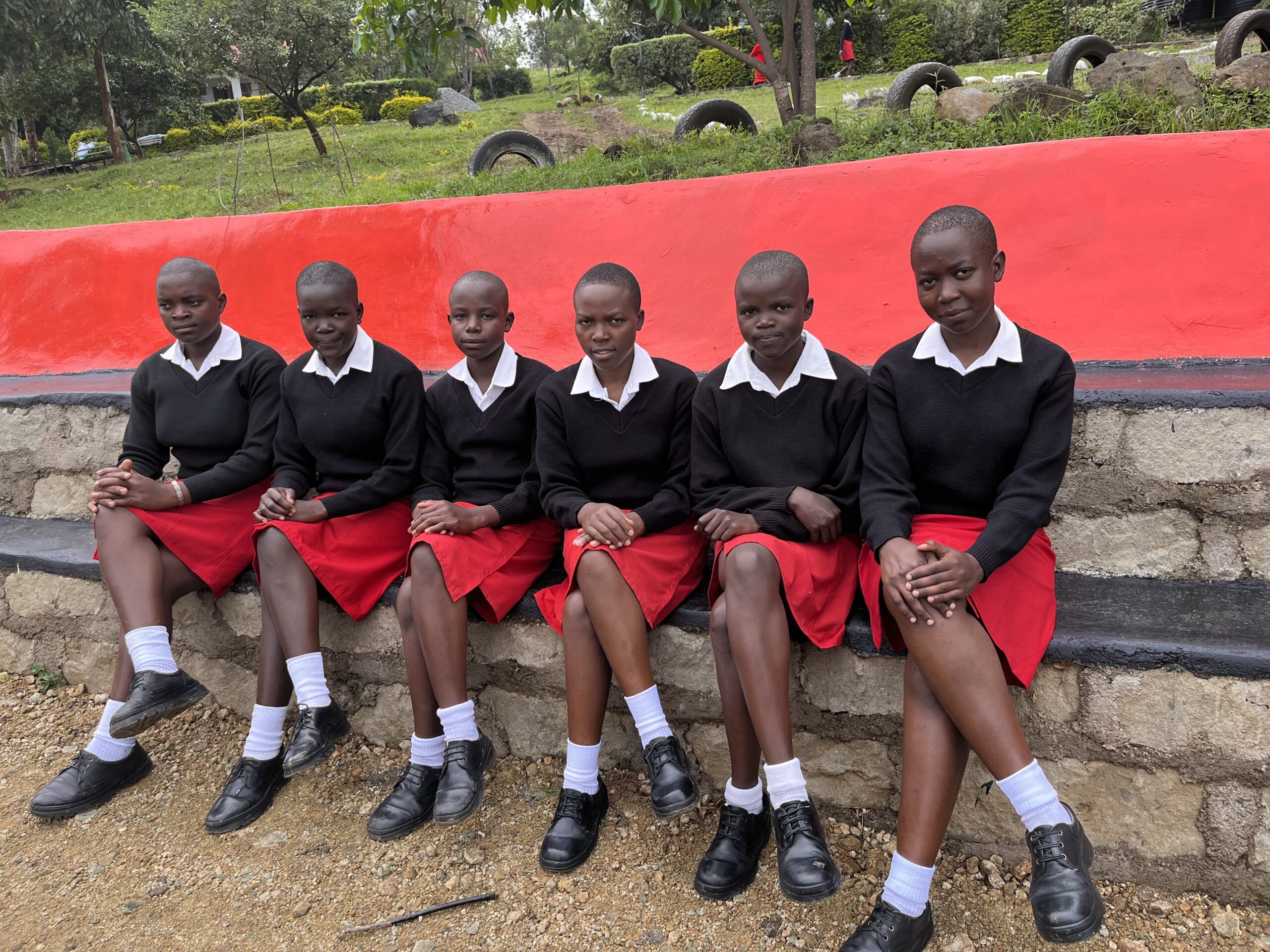 Students Sitting In Row From 12 students in the first class in 2011, JAMS has grown to accommodate more than 200 students today, and will soon house and educate 240 girls.